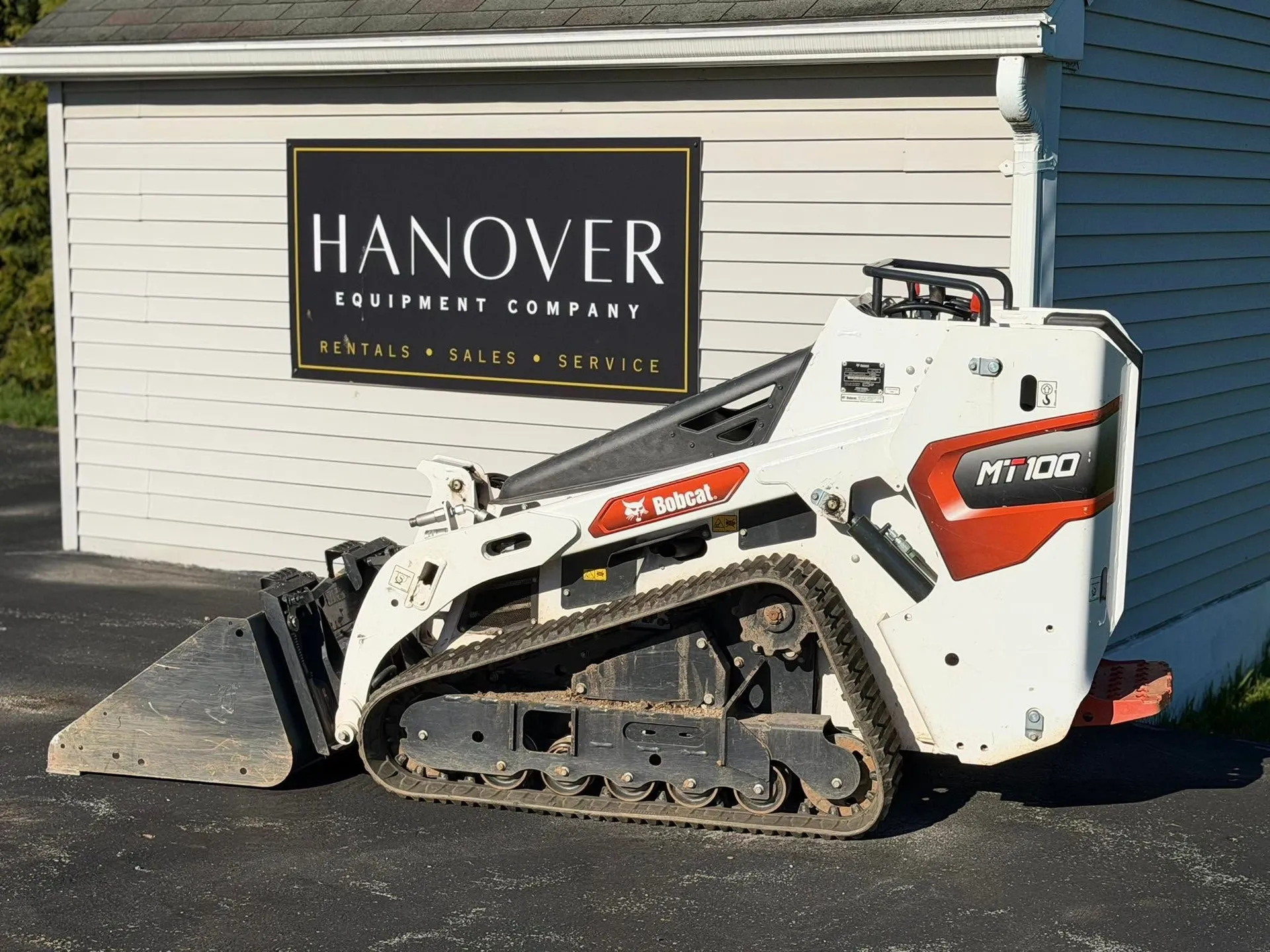 Bobcat MT100 compact track loader parked beside the Hanover Equipment Company sign